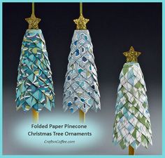 three small christmas trees made out of folded paper with gold stars on top and one in the middle