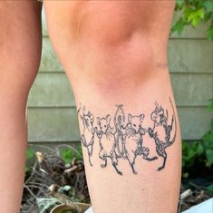 a woman's leg with tattoos on it and some animals in the shape of people