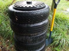 two tires stacked on top of each other in the grass