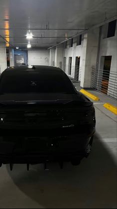 a black car parked in a parking garage