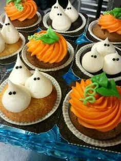 cupcakes with white frosting and halloween decorations