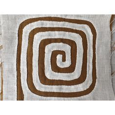 a brown and white pillow with an abstract design