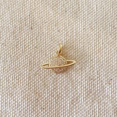 This Saturn pendant crafted from 18k gold-filled is an absolute showstopper. Its refined and intricate design, coupled with the Saturn planet emblem, produces a unique and mesmerizing appearance ideal for any occasion. Offer someone this sparkling accessory, and they will undoubtedly treasure it as a precious gift. Metal: 18k Gold filled 1.5 cm long x 1.5 cm wide Weight: 0.9 grams Hypoallergenic Waterproof Handcrafted in Brazil Saturn Pendant, Saturn Planet, Pendants Gold, Precious Gift, Blue Zircon, Eye Necklace, Gold Filled Jewelry, Intricate Design, Pearl Pendant