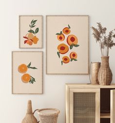 three oranges are hanging on the wall next to vases and other decorative items