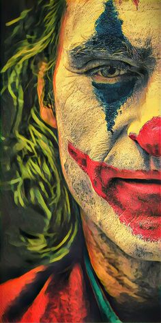 the face of a clown painted in multicolors