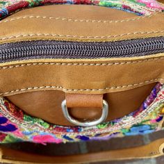 This gorgeous bag is made from a vintage Huipil (pronounced wee-peel). A huipil is woven on a backstrap loom, which consists of 5-6 pieces of wood and a strap that goes around the weaver's waist, making her part of the loom. The leather used in this bag is soft and luxurious and made in Quetzaltenango, nicknamed by locals as Xela. Prounounced "She-lah", Xela leather is considered one of the finest in Guatemala. Measures: 11” H x 14”L The interior is beautiful Corte (Traditional skirt worn by May Traditional Woven Leather Shoulder Bag For Travel, Traditional Woven Leather Bag, Traditional Leather Bag With Woven Details, Handwoven Leather Crossbody Shoulder Bag, Handwoven Leather Hobo Bag, Traditional Woven Leather Bags For Daily Use, Multicolor Woven Leather Bags, Traditional Woven Leather Shoulder Bag For Daily Use, Handwoven Leather Crossbody Satchel