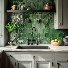 a kitchen with green hexagonal tiles on the backsplash and gray cabinets