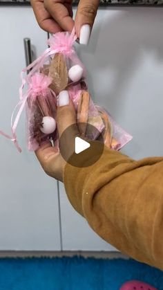 two people holding candy in their hands while one person puts them on the other hand