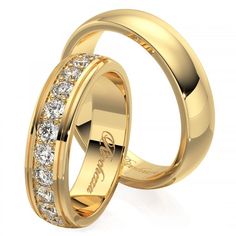 two gold wedding rings with diamonds on each side and the word love written in cursive