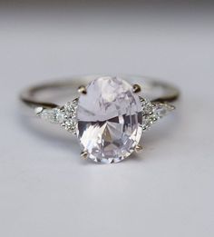 an oval cut diamond ring with three side stones