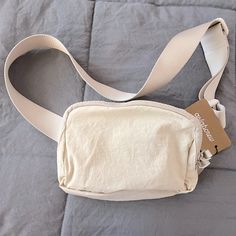 Tan Unisex Belt Bag. Nwt Soft Nylon With Durable Adjustable Belt. Belt 22”-40” And Bag Is 8” X 5.5” X 2” Many Pockets Holds More Than You Think. Cream Nylon Bag For Everyday Use, Casual Nylon Canvas Bag For Everyday Use, Everyday Rectangular Nylon Canvas Bag, Everyday Nylon Canvas Bag With Pockets, Everyday Beige Nylon Bag, Everyday Nylon Canvas Bag, Everyday Cream Nylon Bag, Cream Nylon Everyday Bag, Casual Beige Belt Bag For On-the-go