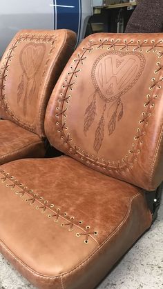 two brown leather seats sitting next to each other