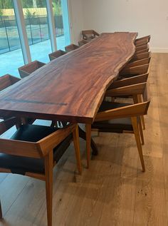 a large wooden table with six chairs around it