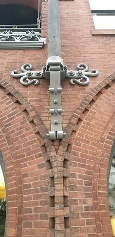 an ornate cross on the side of a brick building