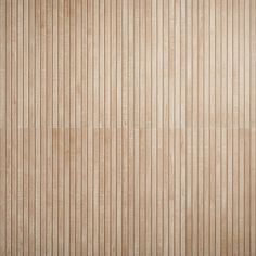 a wooden wall with vertical lines painted on the wood paneling in light brown tones