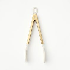 an open pair of scissors on a white background with clippings in the middle