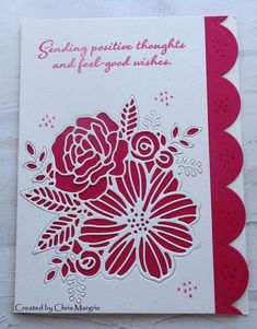 a red and white card with flowers on it