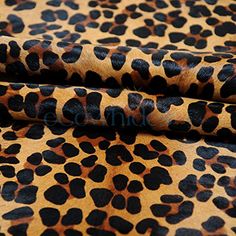 leopard print fabric with black and brown spots on the top, in an animal - print pattern