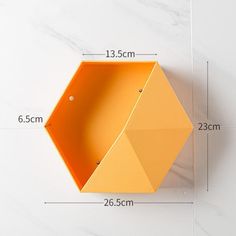 an orange hexagonal object is shown with measurements for the size and widths