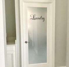 a white door with the words laundry on it and a mirror in front of it