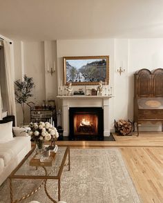 a living room filled with furniture and a fire place in the middle of a room