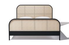 an upholstered bed with black frame and white pillows on the headboard, in front of a white background