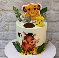 a cake decorated with an image of a lion and other animals on top of it