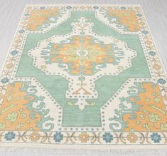 an area rug with many different colors and designs on it, including blue, green, orange