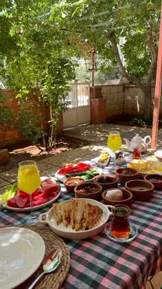 a table with plates and bowls of food on it