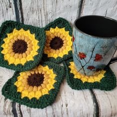 four crocheted coasters and a coffee cup