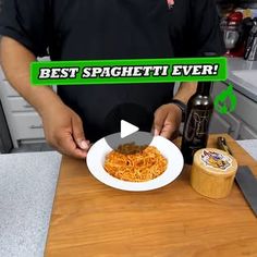 a man holding a plate of spaghetti in his hands