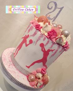 a birthday cake decorated with pink and white icing