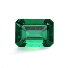 an emerald green tourmaline stone on a white background