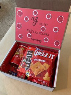 an open box filled with snacks on top of a table