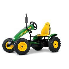 a green and yellow children's ride on toy tractor with large tires, steering wheel and seat