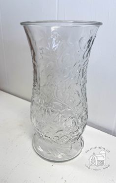 a clear glass vase sitting on top of a table