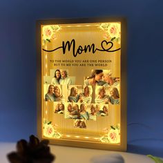 a lighted photo frame with the words mom on it and images of people in them