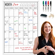 a woman standing in front of a calendar