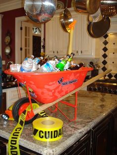 a wheelbarrow filled with bottles and cans sitting on top of a kitchen counter