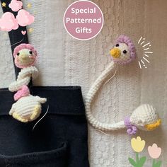 two crocheted stuffed animals are attached to the side of a black bag with pink and yellow flowers