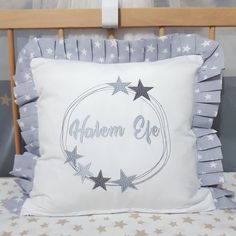 a white pillow with silver stars on it and the words southern eye in a circle