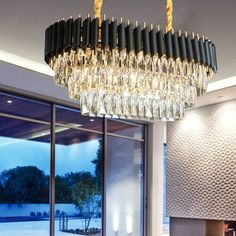 a large chandelier hanging from the ceiling in a living room with glass doors