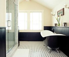 a black and white bathroom with a claw foot tub