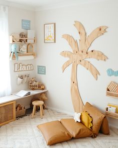 a child's bedroom with a palm tree cut out on the wall and toys