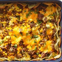 a casserole dish filled with meat, cheese and corn is ready to be eaten