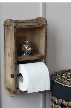 a wooden shelf with a roll of toilet paper on it next to a potted plant