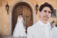 a man and woman standing in front of a door