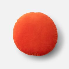 an orange round cushion on a white background