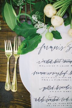 a place setting with flowers and greenery