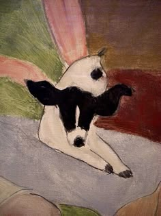 a painting of a black and white dog laying down